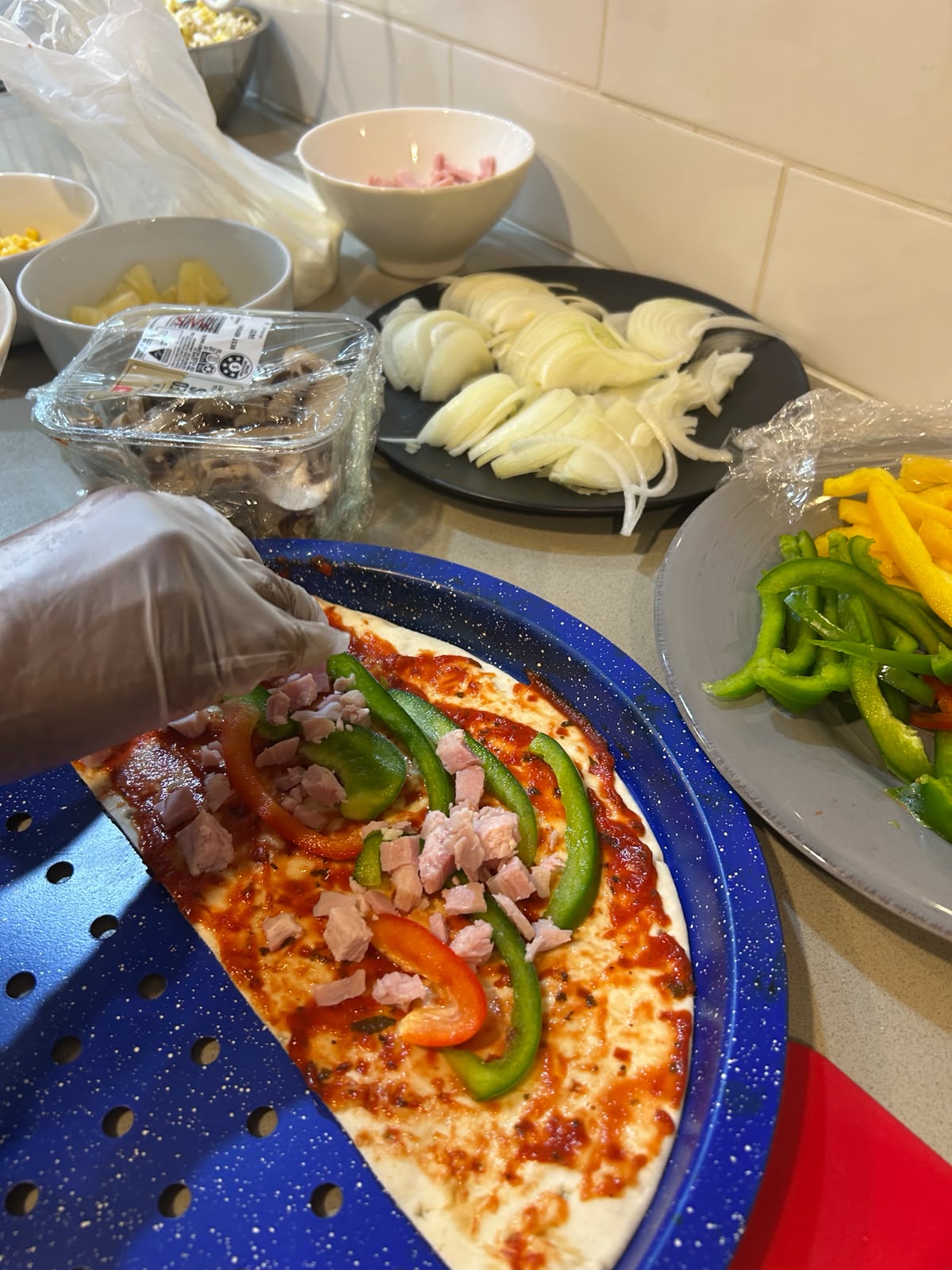 Participants making pizza during a cooking activity